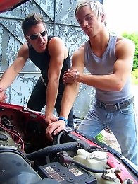 Two muscular gay guys suck dicks at the auto workshop